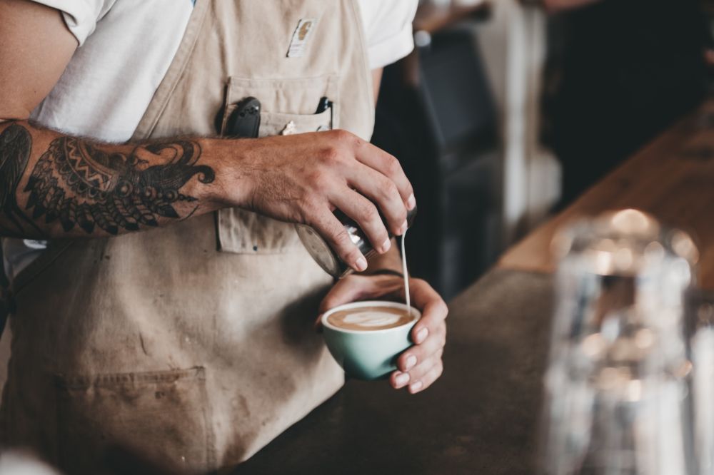 Man creating coffee art